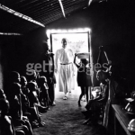 A-figure-in-religious-attire-at-the-doorway-of-a-building-full-of-African-children-during-the-civil-war-in-Biafra-now-part-of-Nigeria-1969