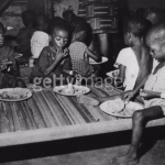 A-group-of-malnourished-children-eat-a-meal-at-a-refugee-centre-during-the-Biafran-famine