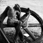 An-amputee-resting-on-a-large-wheel-during-the-civil-war-in-Biafra-now-part-of-Nigeria-1969