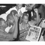 Jubilant-Nigerians-in-the-capital-city-of-Lagos-cheer-as-they-read-of-the-surrender-of-the-rebel-Biafran-forces-Jan.-12-1970